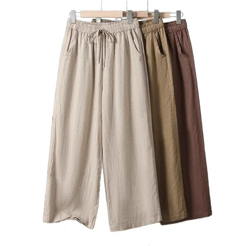 Women's straight-leg casual trousers with elastic drawstring waist in apricot colour.