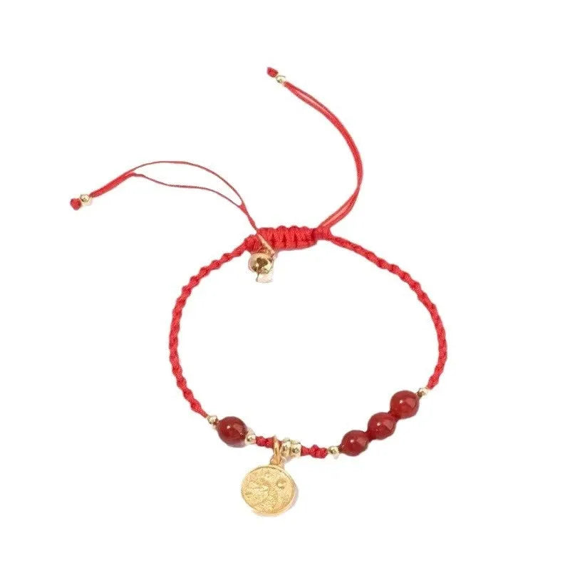 Cinnabar Ashore braided rope good luck bracelet with a blessing card charm.
