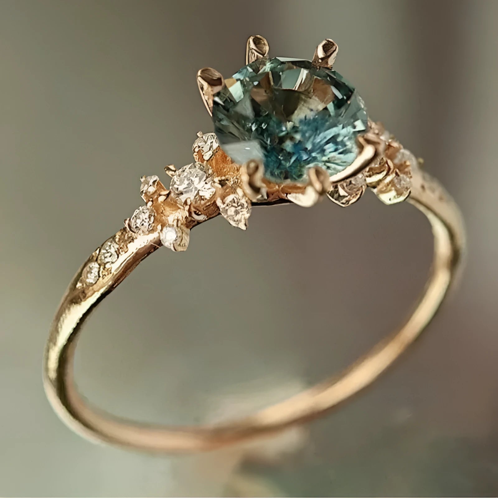 Gold plated geometric claw ring with zircon inlay on a chamfered square pattern design.