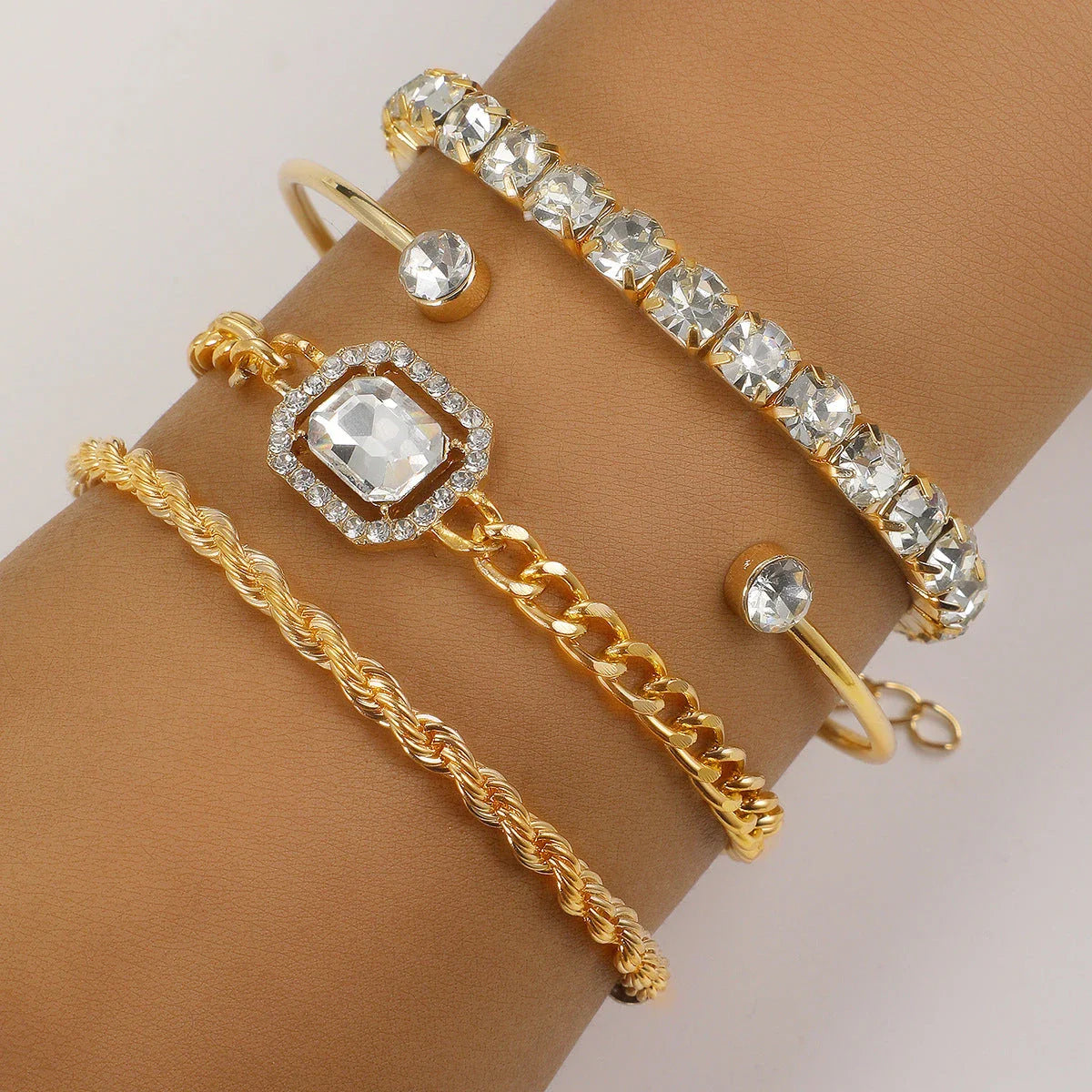 Premium 4-piece crystal bracelet set with adjustable fit and sparkling rhinestone embellishments, perfect for adding a touch of glamour to any outfit.