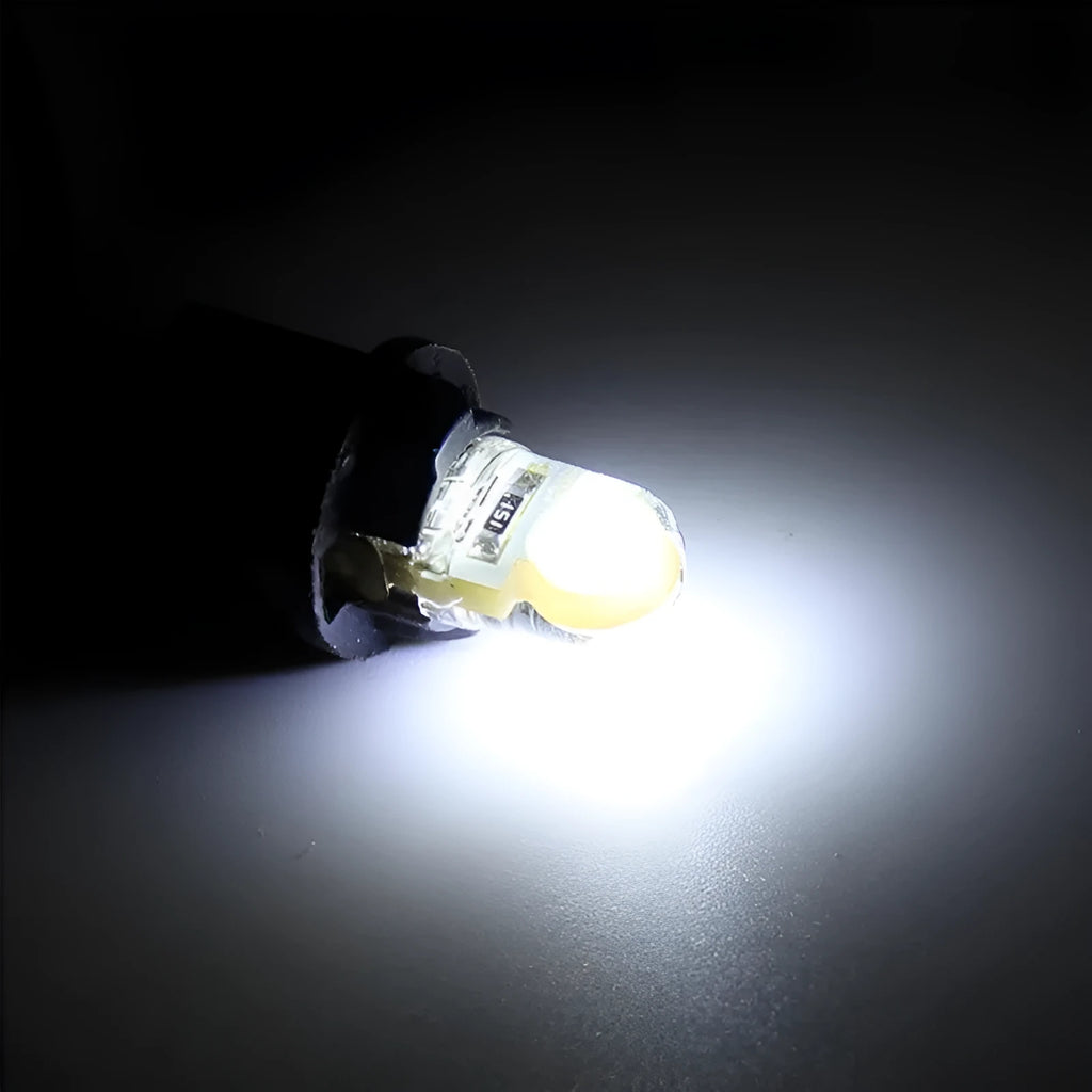 Ten silicone T10 LED car bulbs in various colours including white, red, blue, and yellow on a white background.