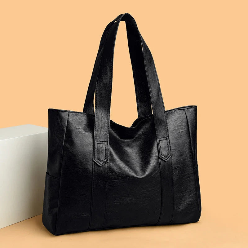Large capacity commuter tote bag in brown and black with double shoulder straps and mobile phone pocket