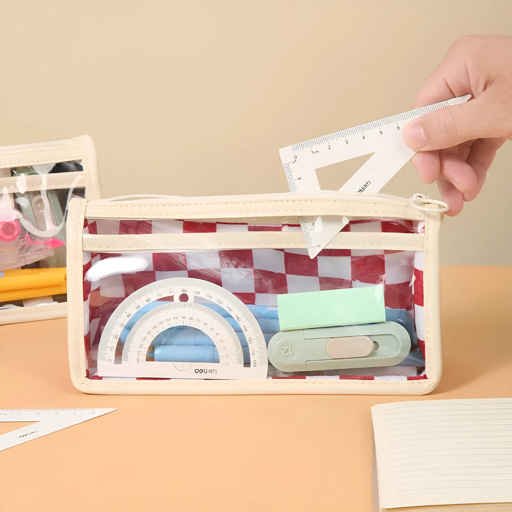 Transparent PVC pencil case showing internal chessboard grid pattern, measuring 21.5cm long.