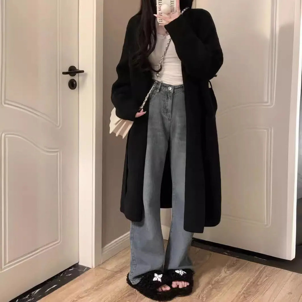 Women's khaki loose-fit knitted V-neck cardigan on a hanger, showing mid-length and long sleeves.