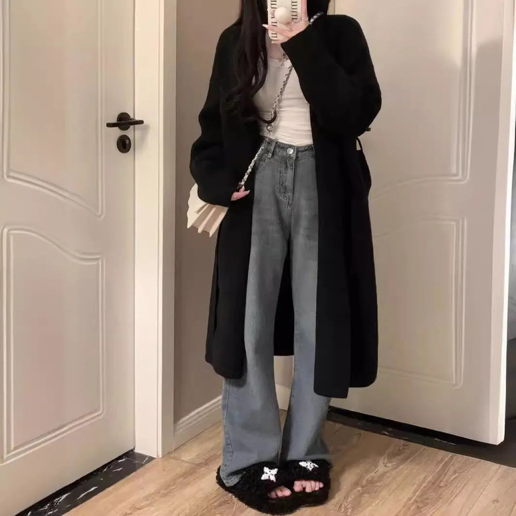 Women's khaki loose-fit knitted V-neck cardigan on a hanger, showing mid-length and long sleeves.