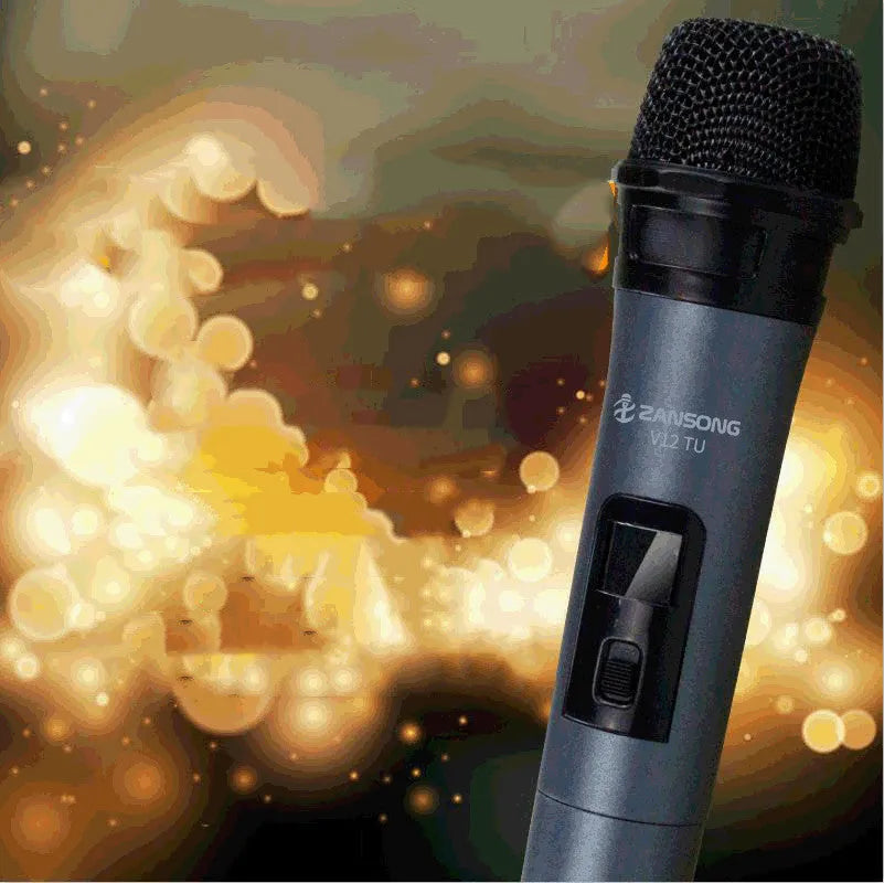 Black dynamic microphone with metal grill, USB receiver, adapter, and audio cable on dark background