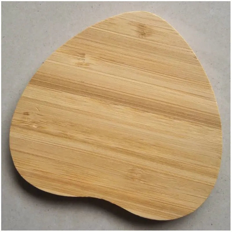 Square natural bamboo 5W QI wireless charging pad on a wooden surface.