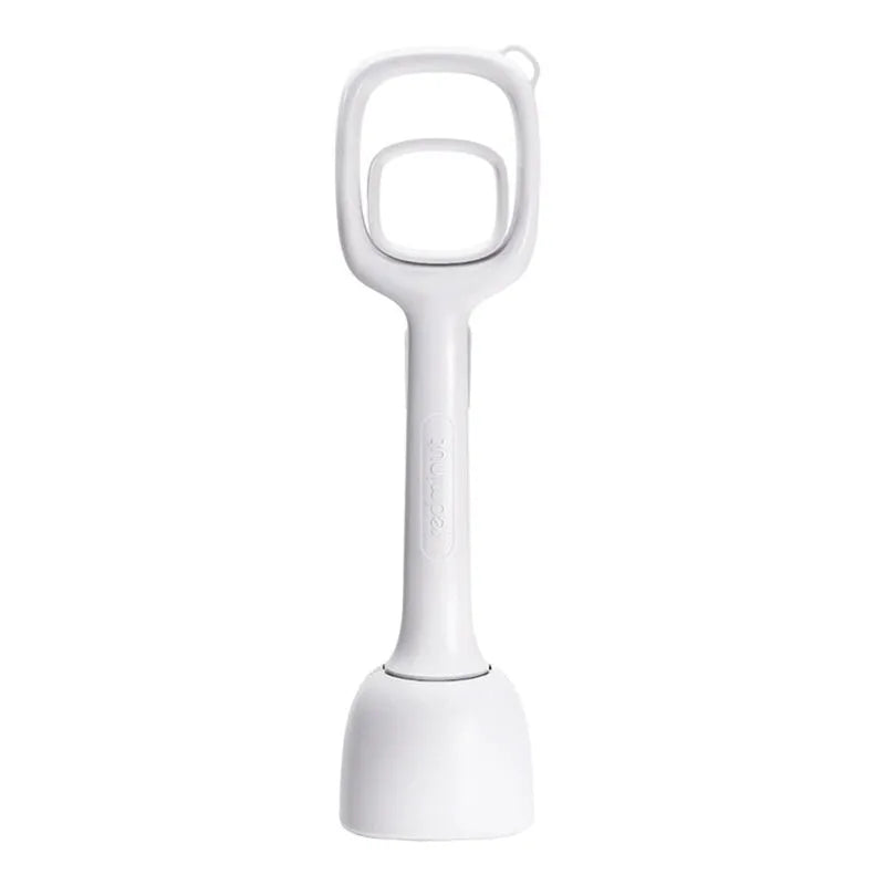White plastic pooper scooper with clip shovel design for dog waste pick-up on grass