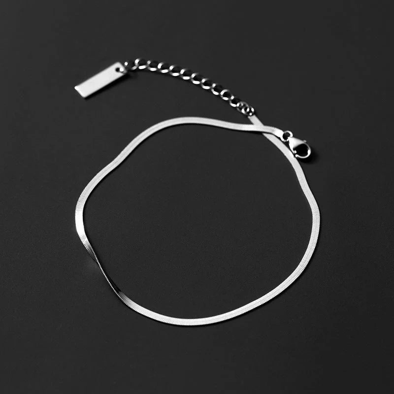 S925 silver snake bone chain anklet in silver and gold finishes, showcasing unique design and craftsmanship.