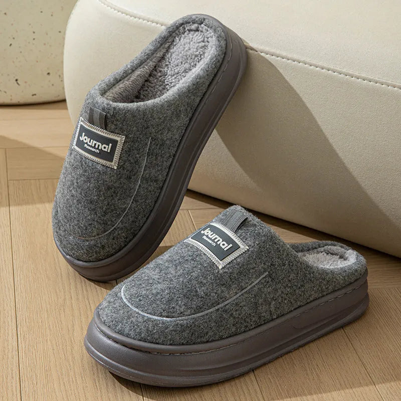 Men's brown suede slippers with a thickened design and textured EVA sole, shown on a wooden floor.