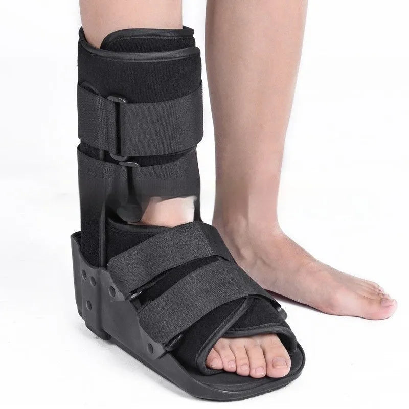 Grey and black adjustable Achilles tendon rehabilitation walking boot with plastic shell and straps.
