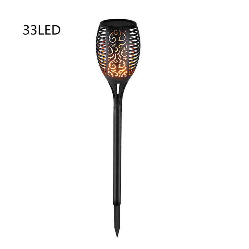 Solar-powered outdoor torch lights with vibrant LED displays automatically illuminating a garden pathway at night