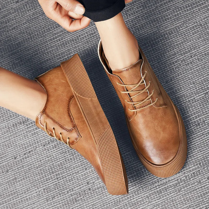 Men's lace-up platform board shoes in solid brown with round toe and low-top silhouette on a neutral background