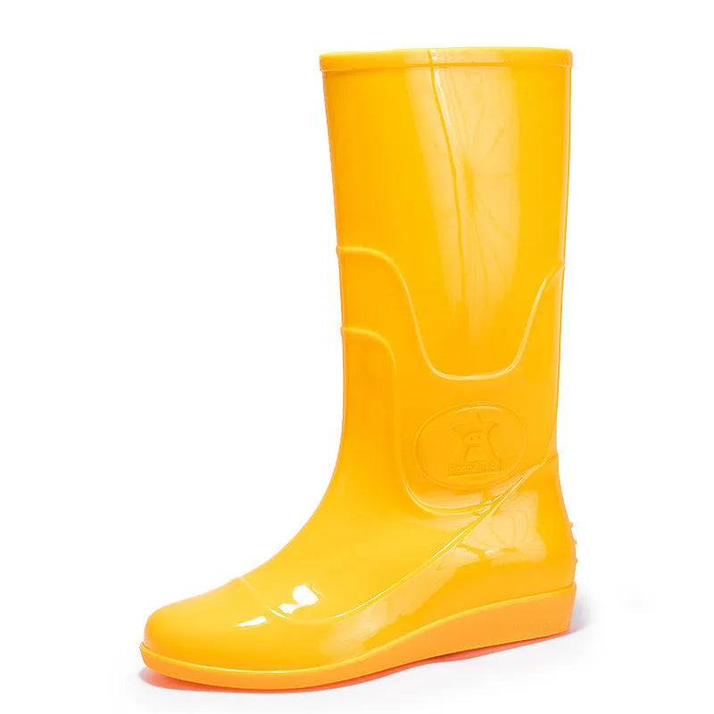 White and yellow high tube plastic rain boots with flat heel and round toe.