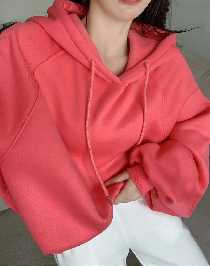 Watermelon red women's loose mulberry silk hooded sweater on a hanger.