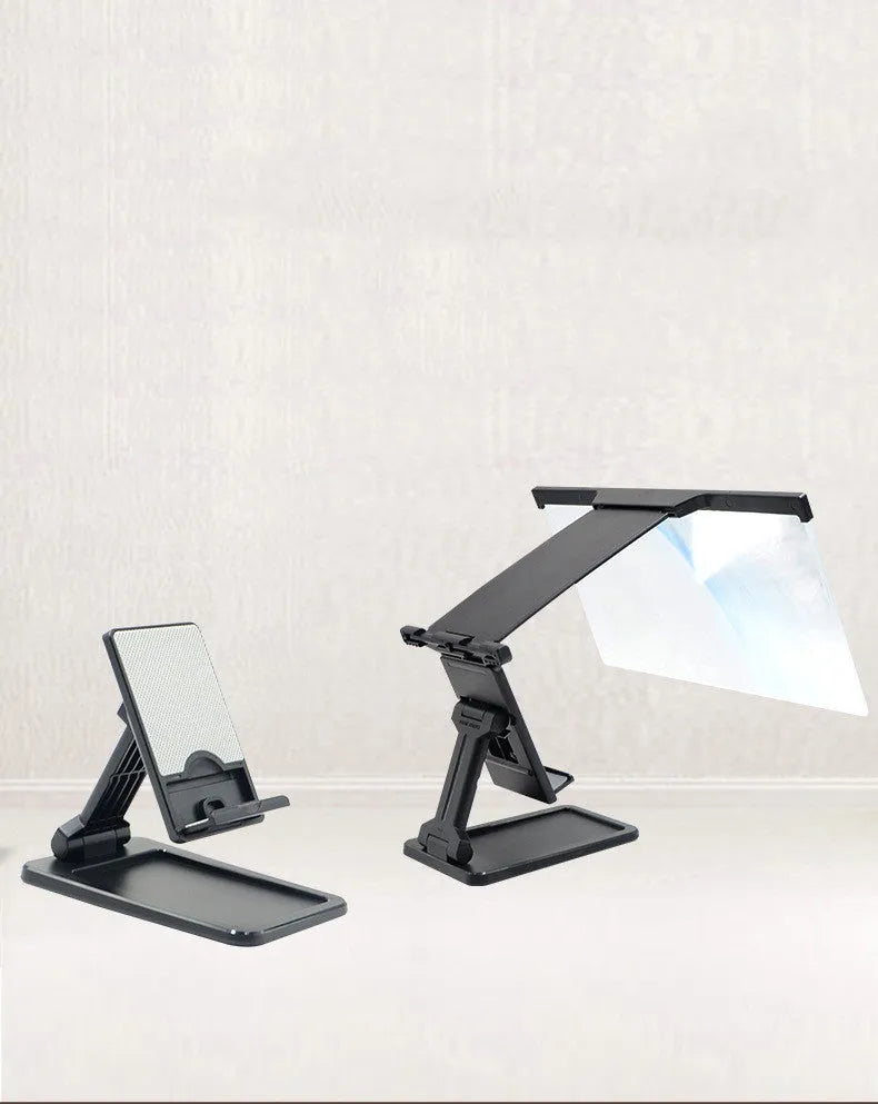 Black folding mobile phone screen magnifier and detachable holder on a desktop.