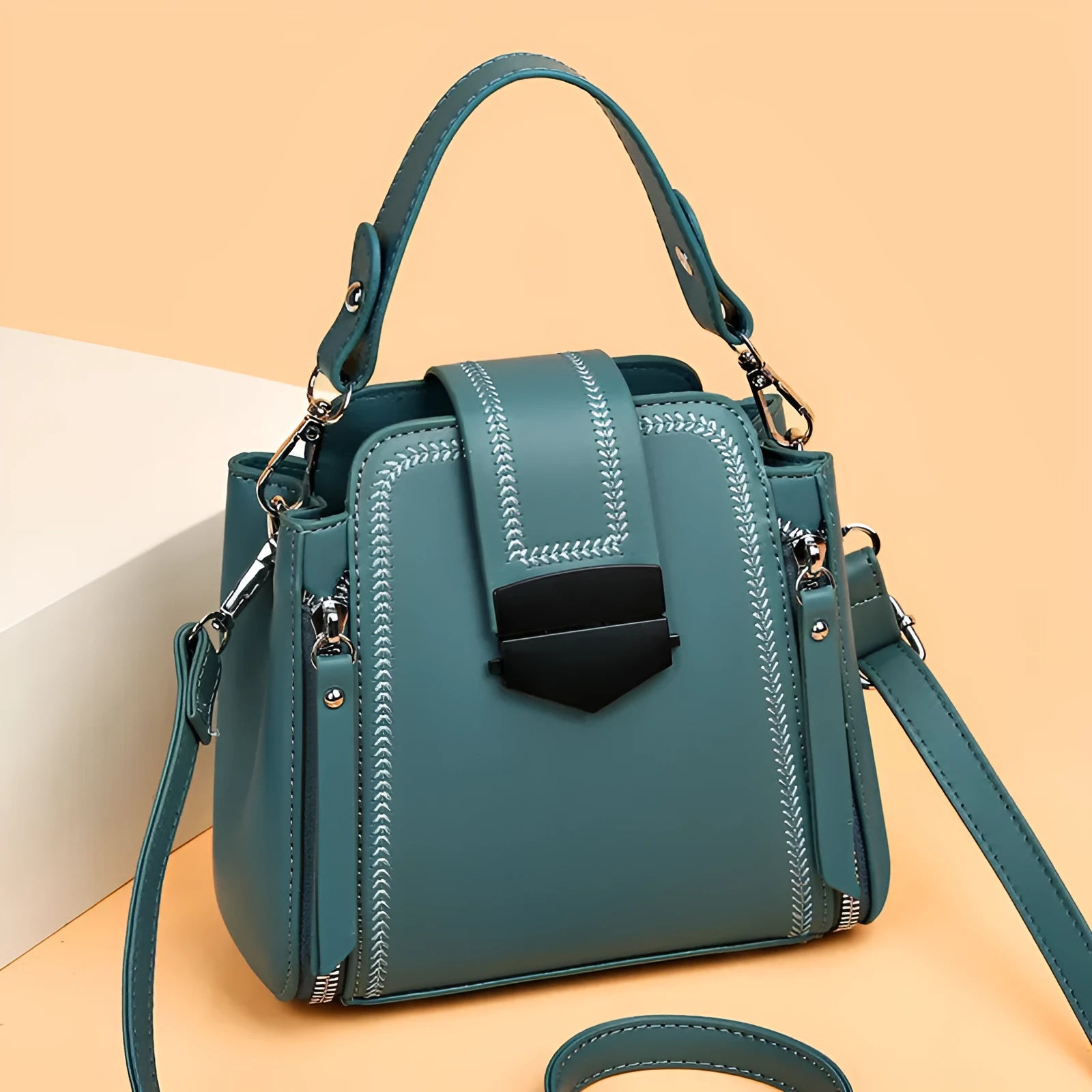 Soft black PU leather square vertical ladies handbag with textured stitching.