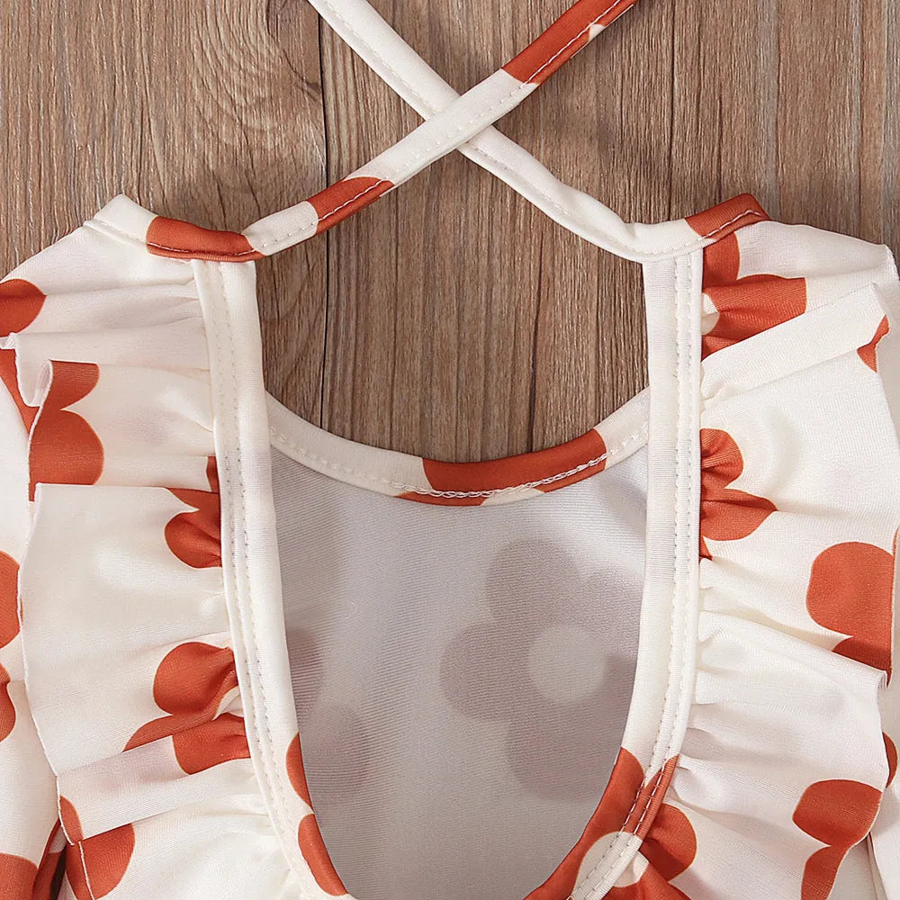 Girl's floral print swimsuit with crew neckline and open back design in orange colour