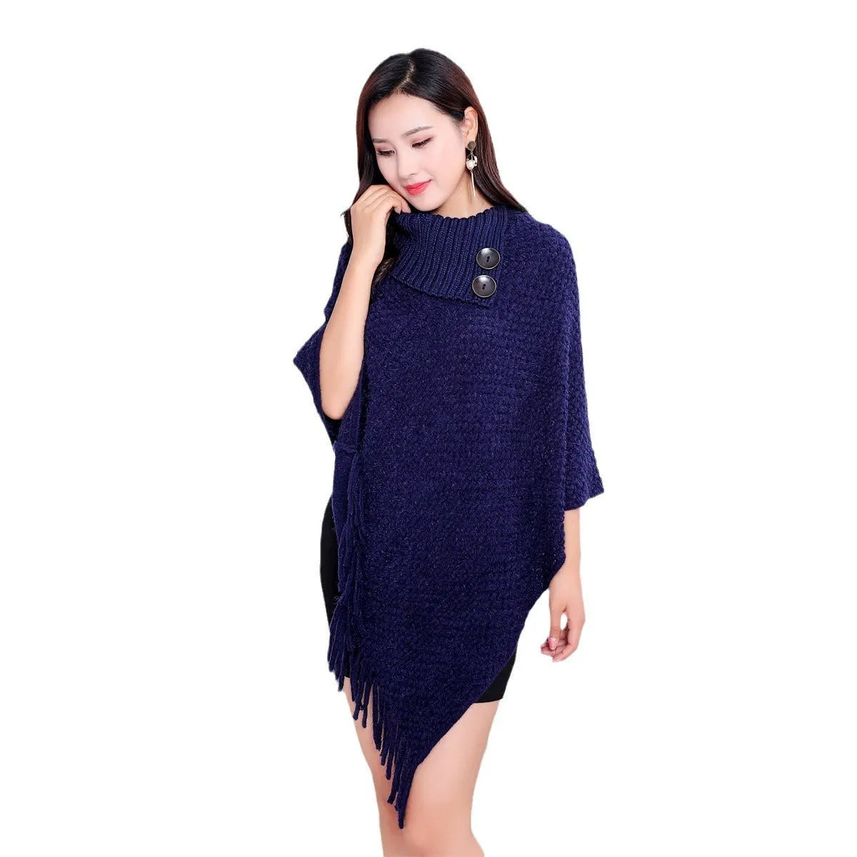 Sleeveless dot pattern knit cloak poncho in apricot colour, laid flat.