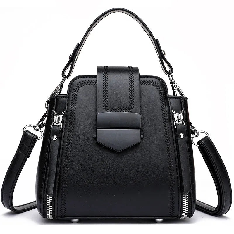 Soft black PU leather square vertical ladies handbag with textured stitching.