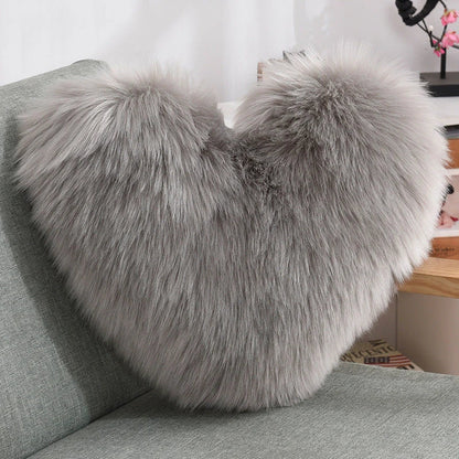 Plush heart-shaped throw pillows in various colors and styles for cozy sofa decor