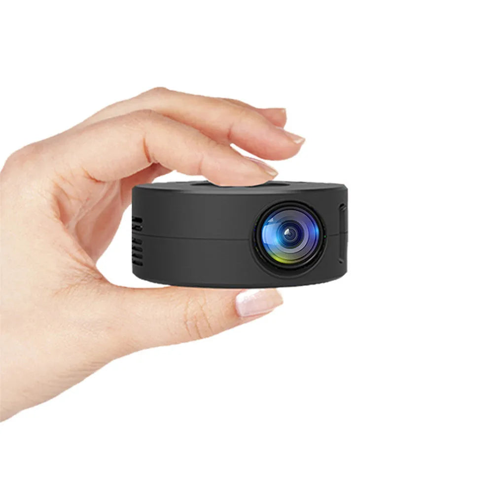 Black mini portable projector for children with phone connectivity on a table.