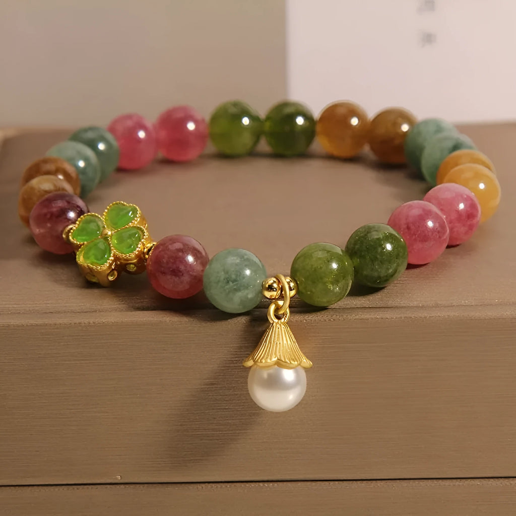 Coloured tourmaline bracelet with four-leaf clover pearl charm and geometric drop beads