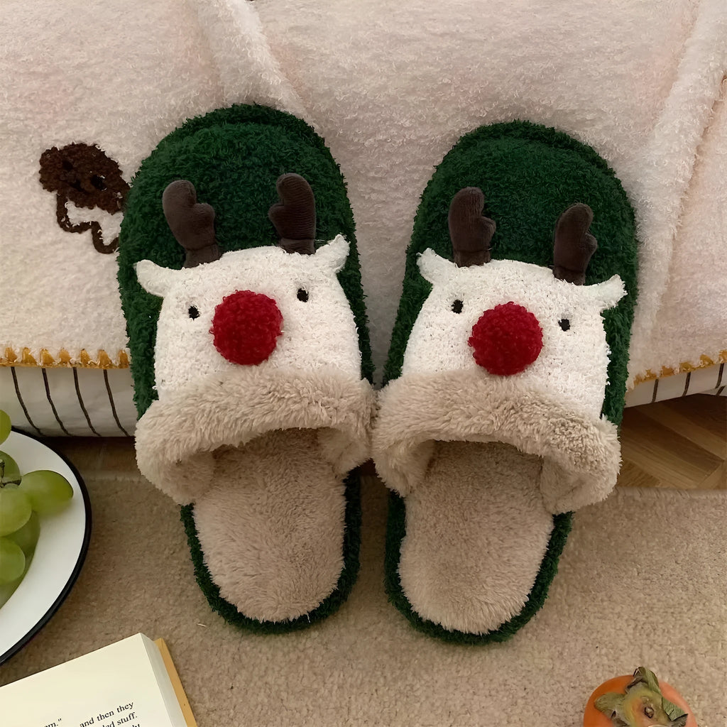 Women's green plush Christmas elk slippers with non-slip PVC sole, shown on a white background.