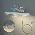 Magnetic suction 40cm rechargeable LED wall lamp in black with remote control, mounted above a bathroom mirror showing three colour temperatures