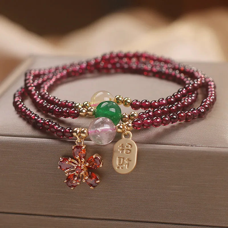 Natural crystal bracelet for women in pomegranate red cherry blossom colour with sequin detailing.