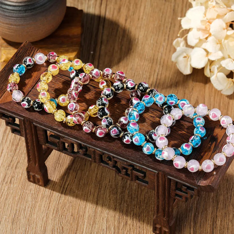 Handmade glass bracelet with swallowing gold beast design and 10mm heart-shaped beads in fluorescent glaze