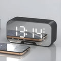 Mini alarm clock Bluetooth speaker in black with LED display, button controls, and USB port