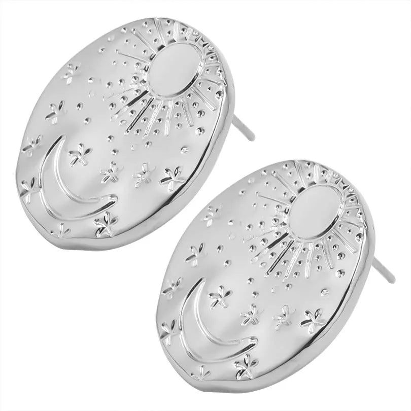 A pair of geometric shell pattern stud earrings in a gold finish on a plain background.