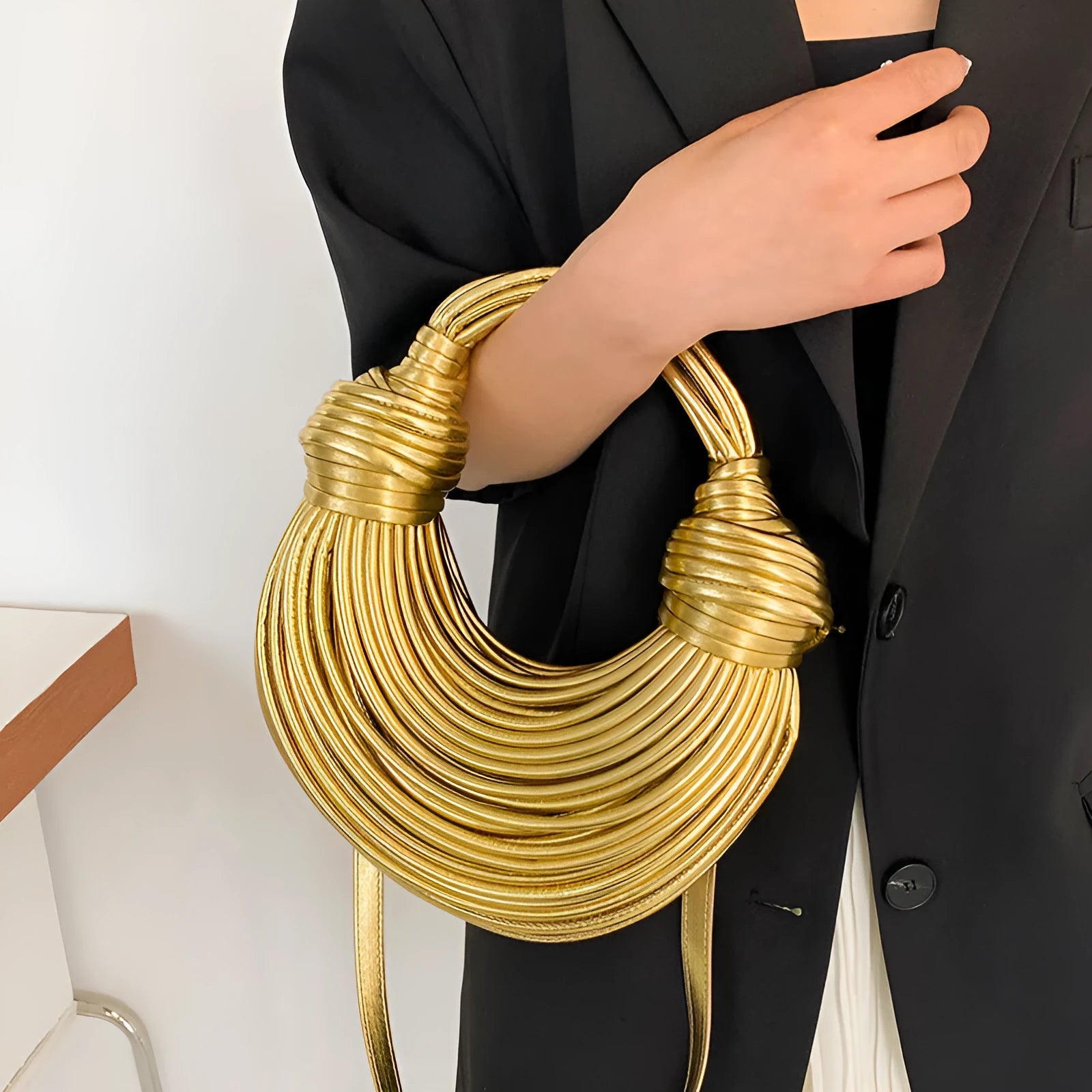 Instafamous Metal Noodles Underarm Bag with shiny metallic surface, chain detail, in gold colour