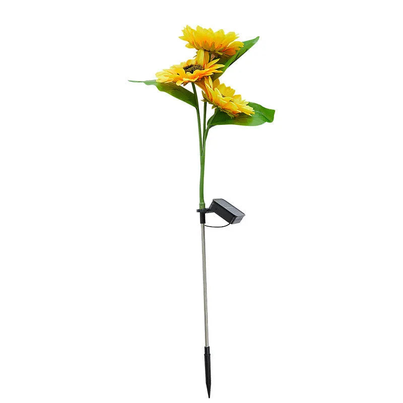 Solar sunflower lawn lamp with three sunflower heads on stainless steel stem in garden