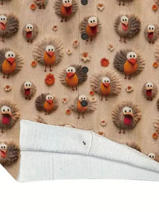 Loose-fit digital printed top with lapel collar on a hanger, showing graphic print design.