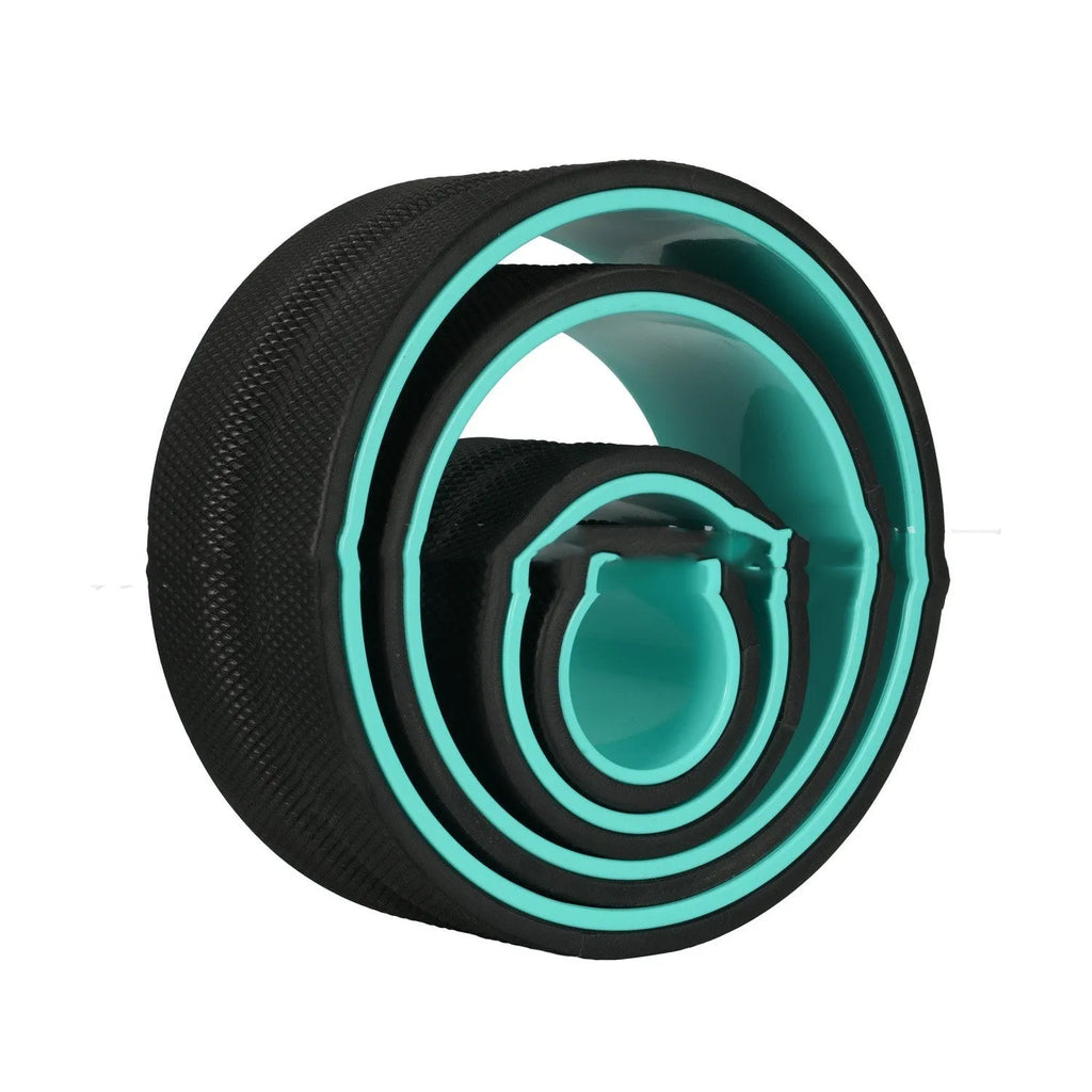 Black yoga wheel four-piece set with foam roller, Pilates ring, and stretching strap on a floor