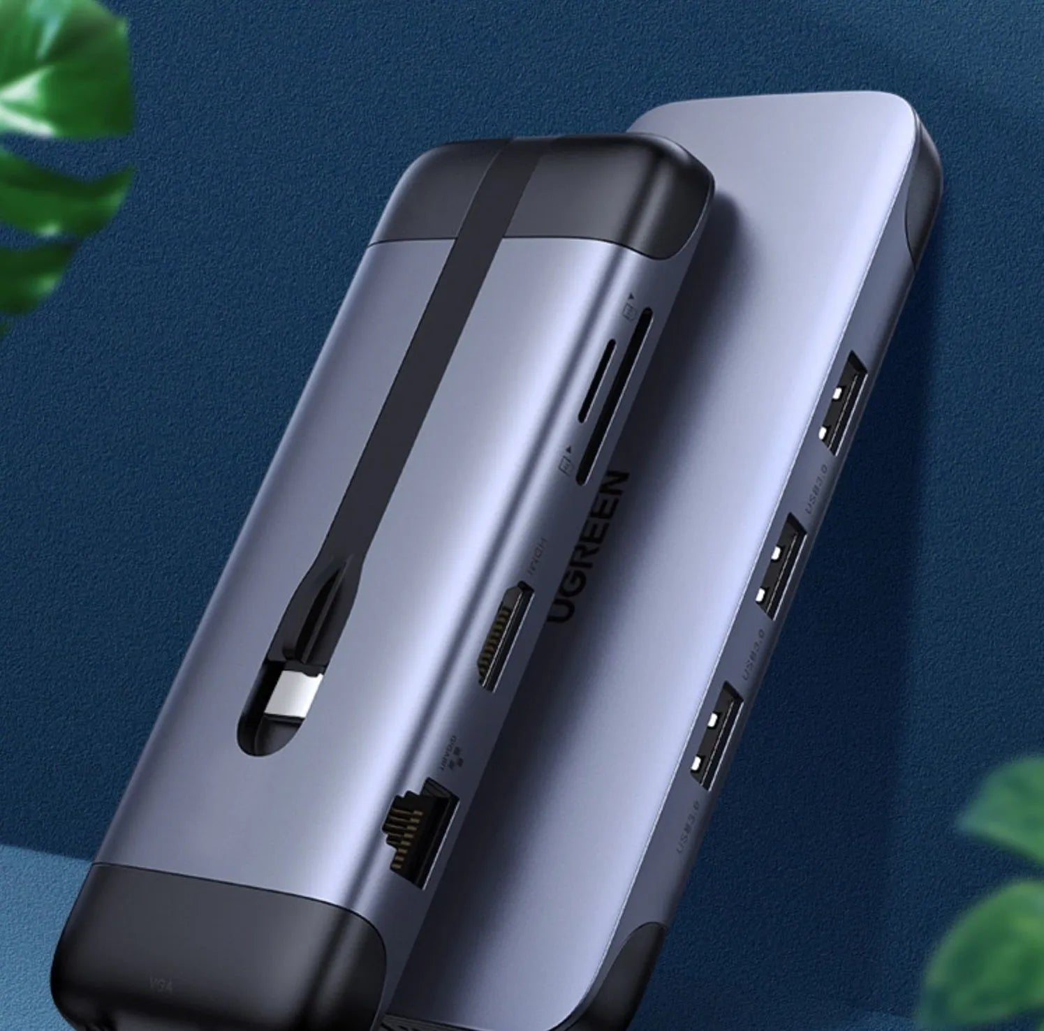 A compact USB-C hub adapter with short cable, showing HDMI, USB 3.0, Power Delivery, and other ports.