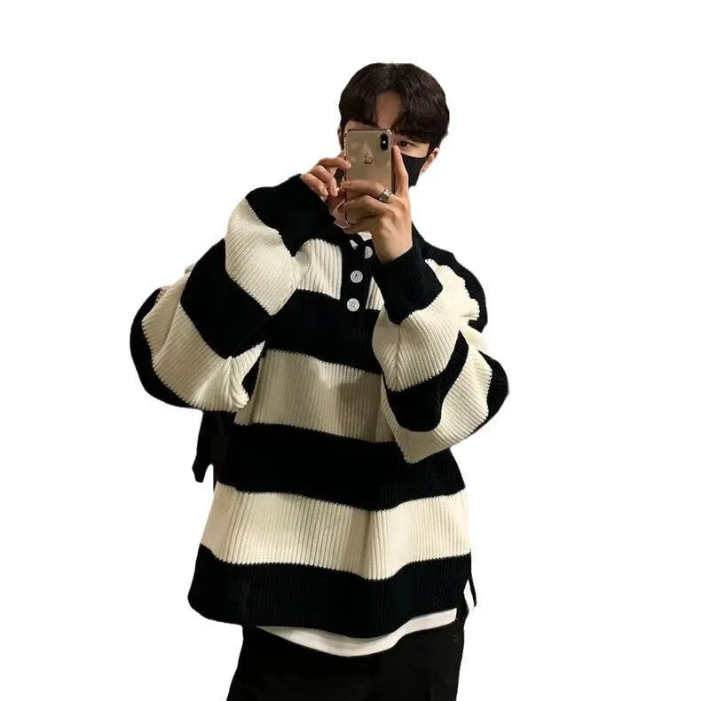 Man modelling a loose fit black and grey striped polyester sweater coat, long sleeve pullover style.