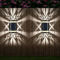 Solar wall light with ABS housing, 80 lumens, warm light projection effect for outdoor garden use