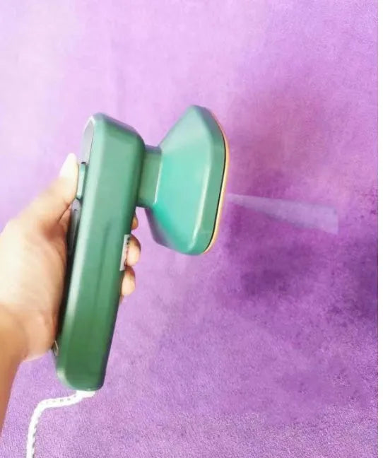 Dark green portable hanging steam iron with ceramic panel and compact design for travel use