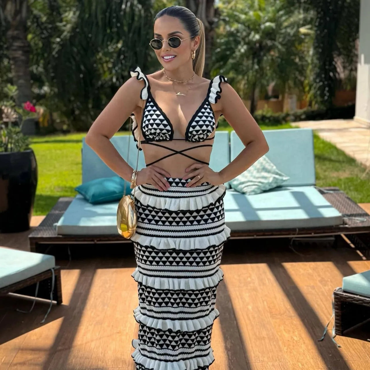 Women's black and white striped bikini top with ruffled straps and matching knitted skirt set