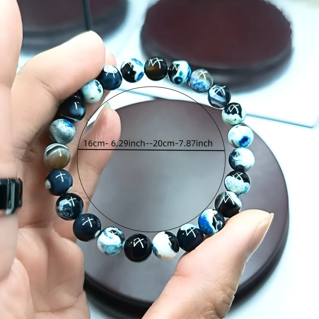 Handmade bohemian bracelet with natural agate and coloured glass beads on a wrist.