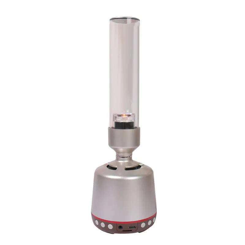 White silver cylindrical Bluetooth speaker and night light unit on a table.