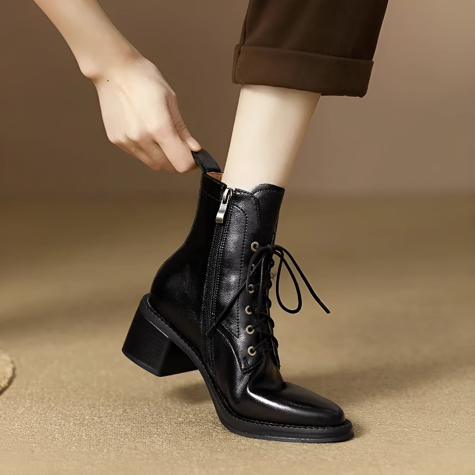 Women's black pointed-toe short tube boots with 5.5cm block heel on wooden floor
