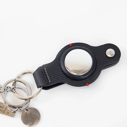 Stylish and durable PU leather AirTag key holder with keychain, available in black and grey colors