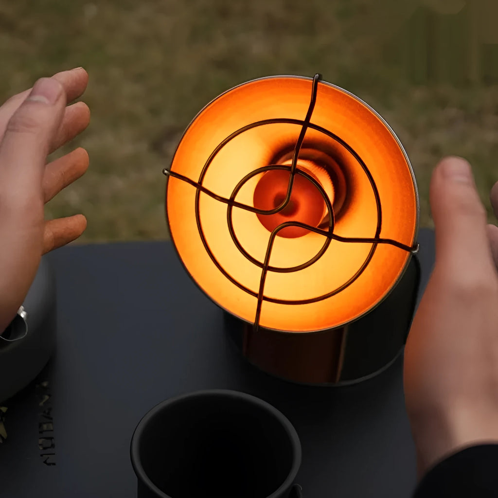 Black and orange portable outdoor gas heating stove with piezo ignition on a table