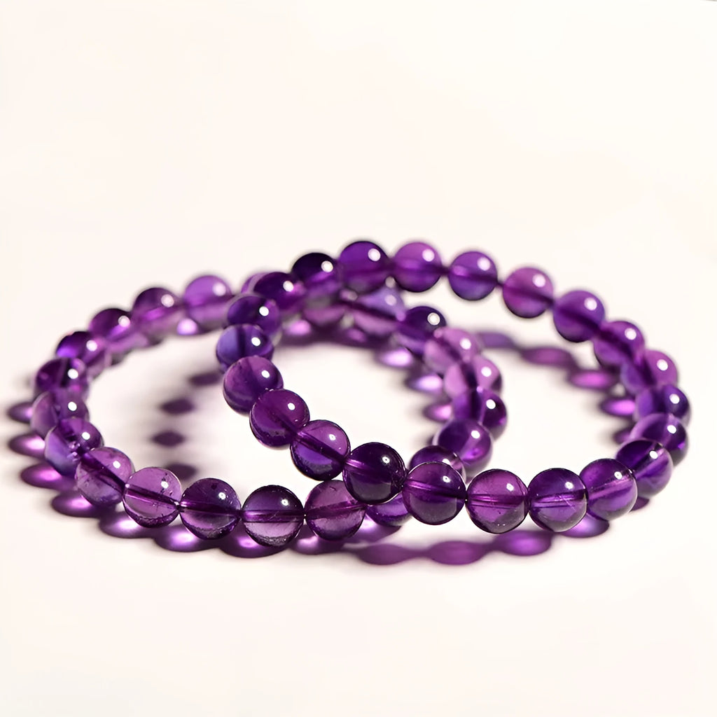 Natural amethyst Uruguay bracelet with scattered polished beads in violet tones, shown in a single circle design.