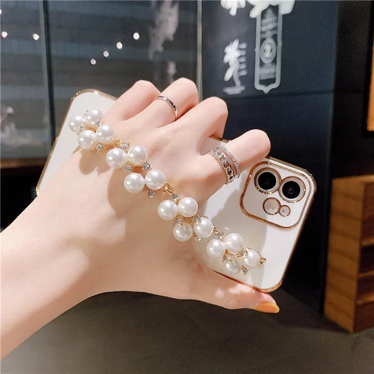 Soft TPU electroplated pearl wrist phone case for Apple iPhone in pink, showing back cover design.
