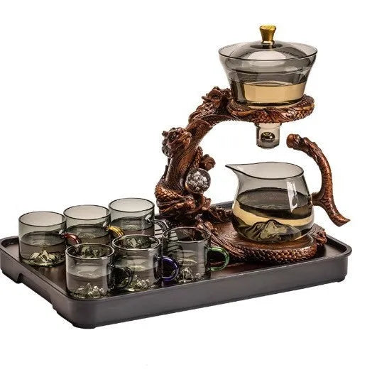 Green gray walnut glass automatic tea set with bowl, base, and fair cup on a table